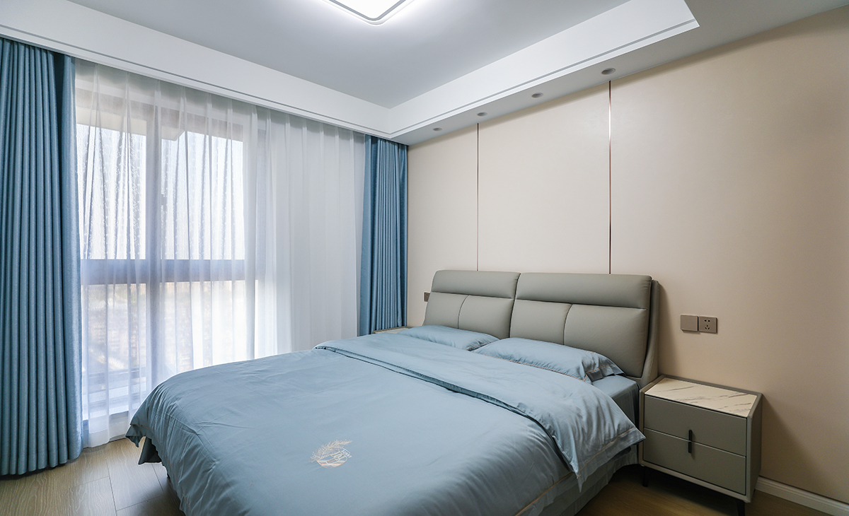 客房有L形衣帽間，平時做儲藏室用，1.8米的床配上70寸電視，讓家里老人來串門時住的安心。同樣做了奶咖色竹木纖維板床頭背景墻，不擔心客人來居住時弄臟床頭墻面。